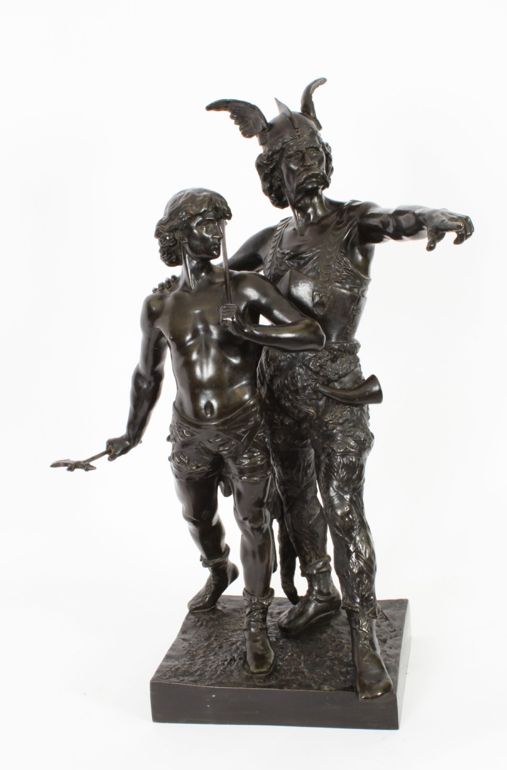 A 19th-century dark patinated bronze sculpture depicting a standing Gaulish warrior with a winged helmet pointing forward next to a young boy holding an axe on a rectangular base.