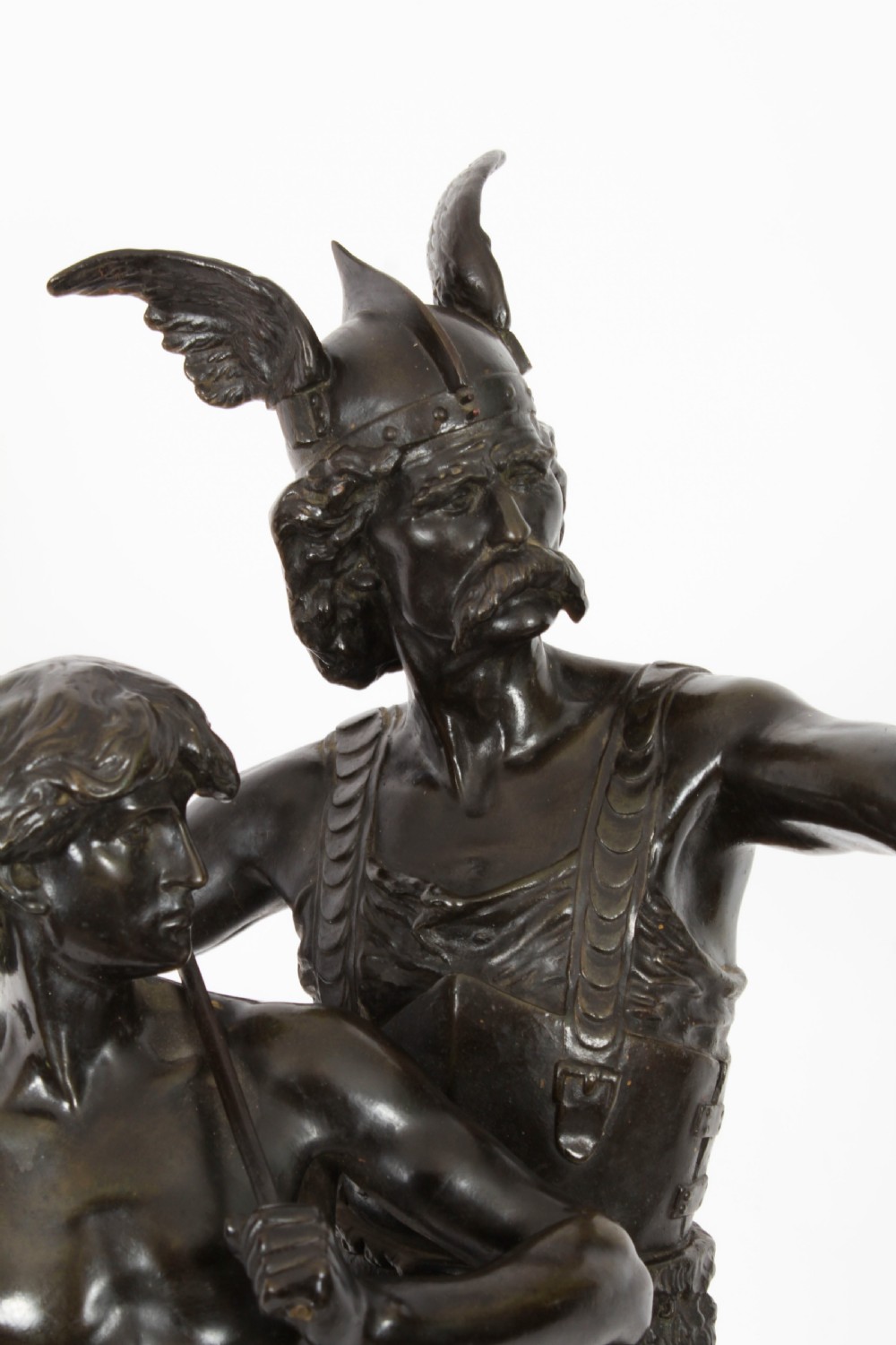 A 19th-century dark patinated bronze sculpture depicting a standing Gaulish warrior with a winged helmet pointing forward next to a young boy holding an axe on a rectangular base. View IV