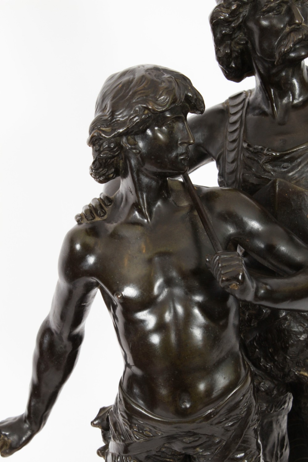 A 19th-century dark patinated bronze sculpture depicting a standing Gaulish warrior with a winged helmet pointing forward next to a young boy holding an axe on a rectangular base. View V