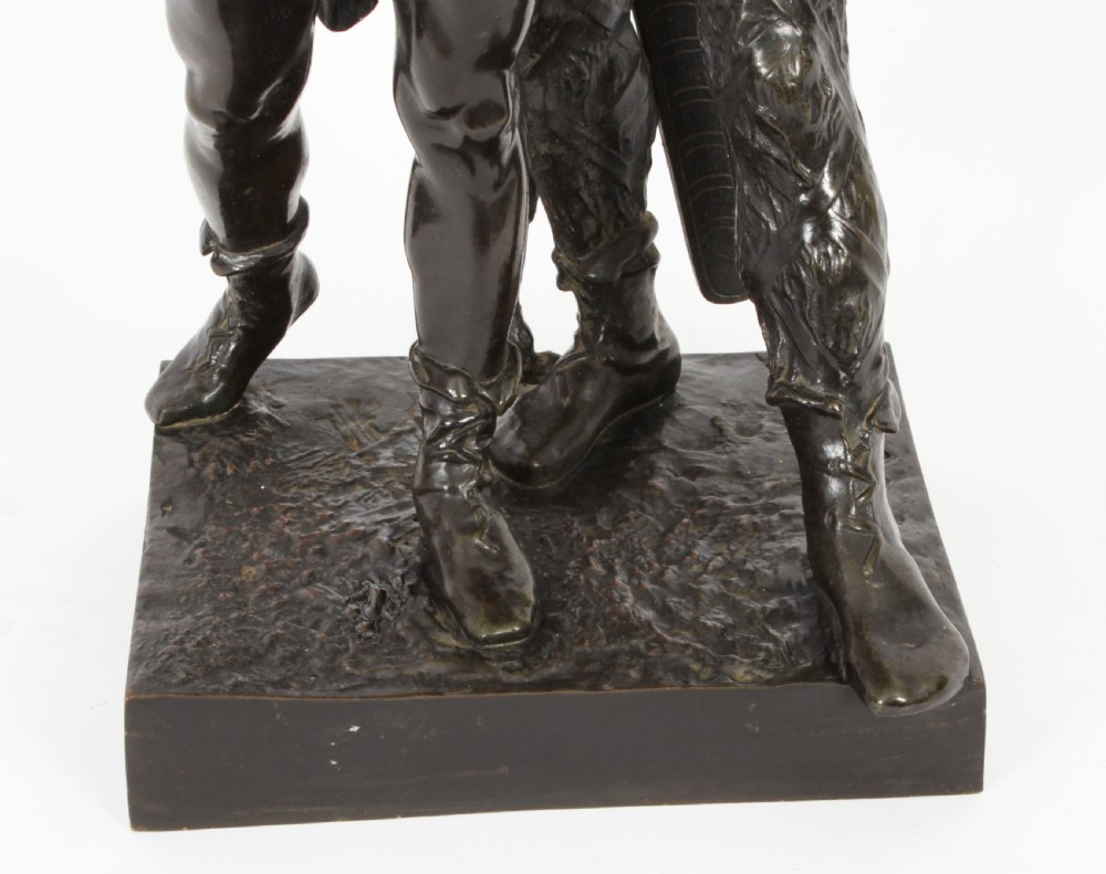 A 19th-century dark patinated bronze sculpture depicting a standing Gaulish warrior with a winged helmet pointing forward next to a young boy holding an axe on a rectangular base. View XV