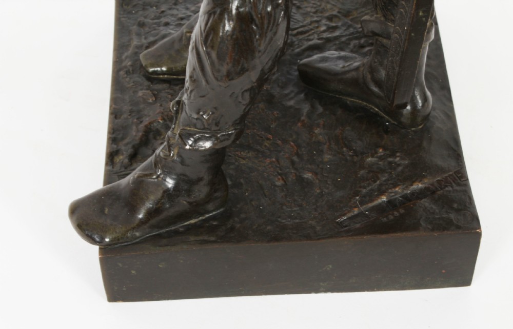 A 19th-century dark patinated bronze sculpture depicting a standing Gaulish warrior with a winged helmet pointing forward next to a young boy holding an axe on a rectangular base. View XVI