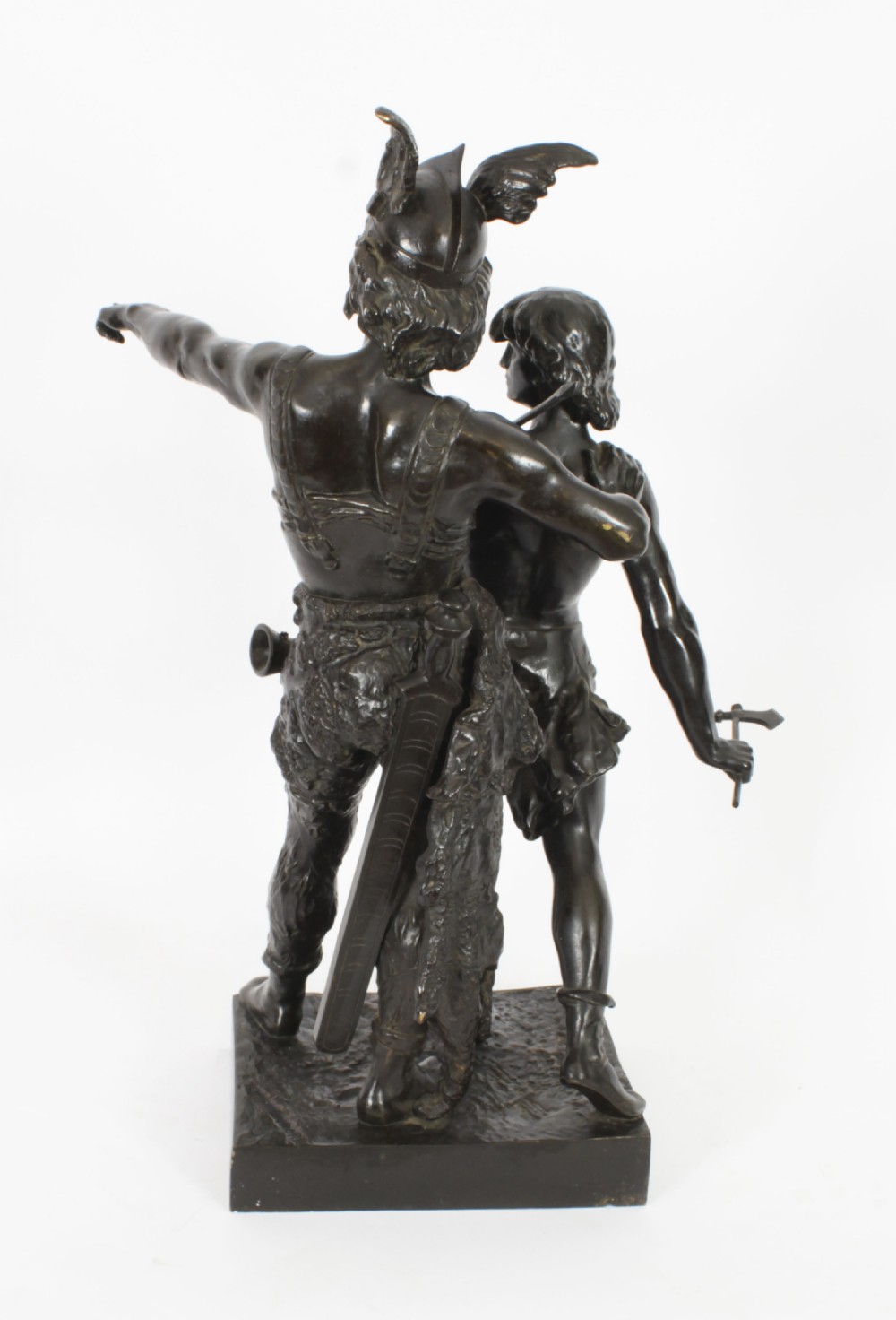 A 19th-century dark patinated bronze sculpture depicting a standing Gaulish warrior with a winged helmet pointing forward next to a young boy holding an axe on a rectangular base. View XVIII