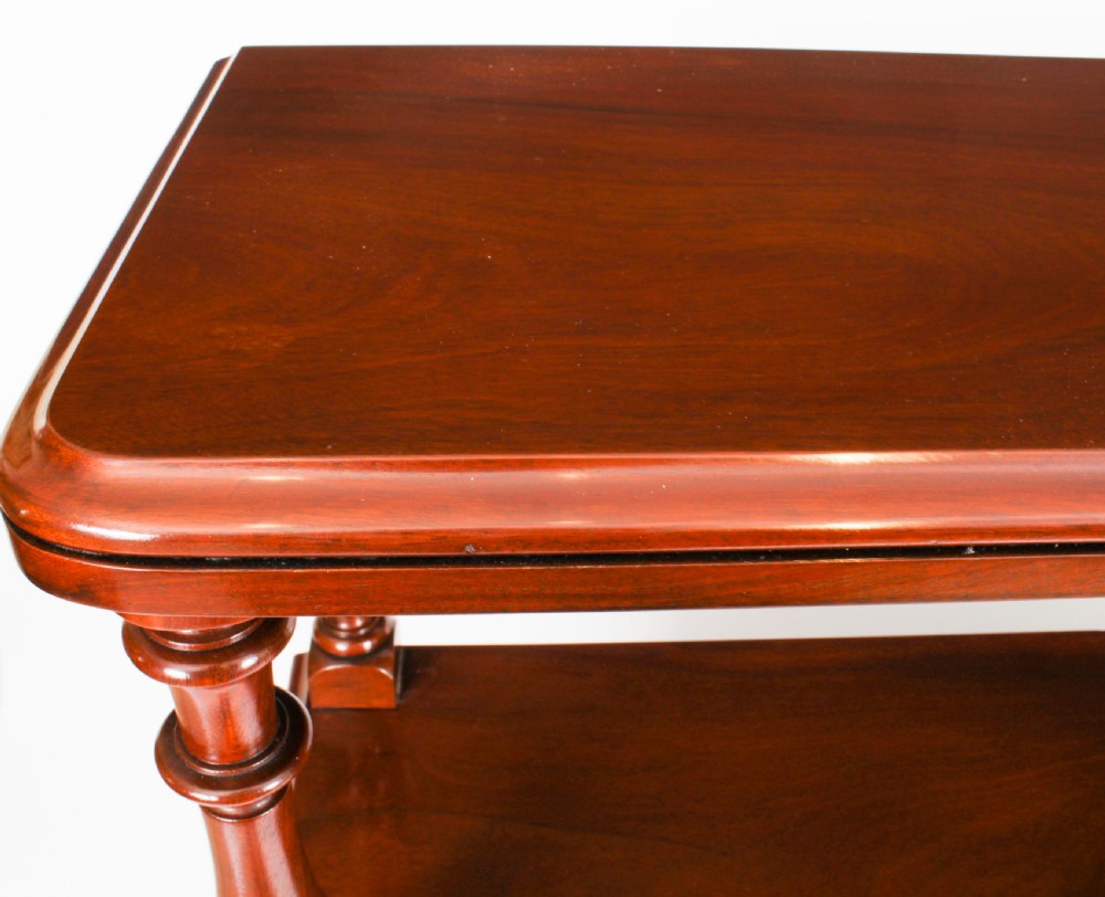 A Victorian flame mahogany dry bar featuring an elevated upper shelf supported by four turned balusters over a panelled lower counter. View V