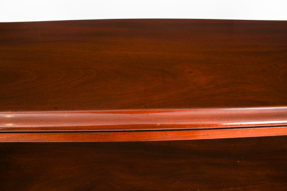 A Victorian flame mahogany dry bar featuring an elevated upper shelf supported by four turned balusters over a panelled lower counter. View VI