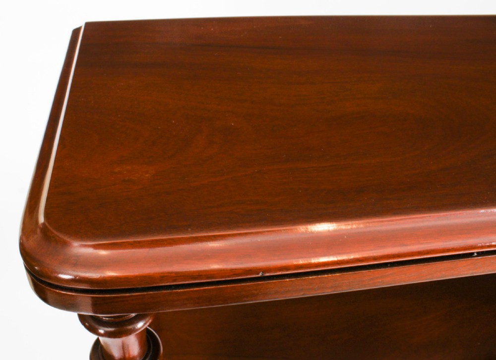 A Victorian flame mahogany dry bar featuring an elevated upper shelf supported by four turned balusters over a panelled lower counter. View VII