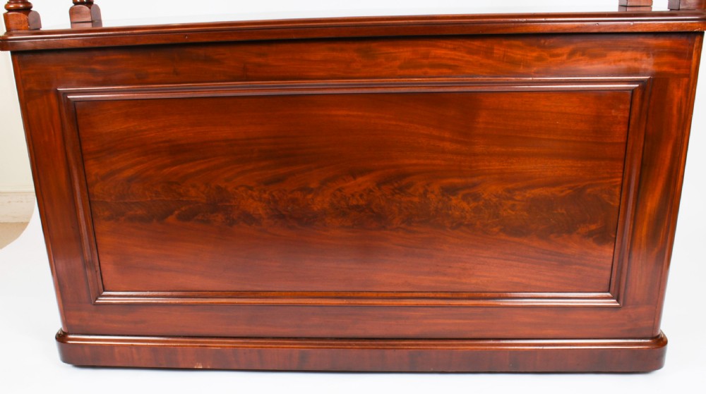 A Victorian flame mahogany dry bar featuring an elevated upper shelf supported by four turned balusters over a panelled lower counter. View IX