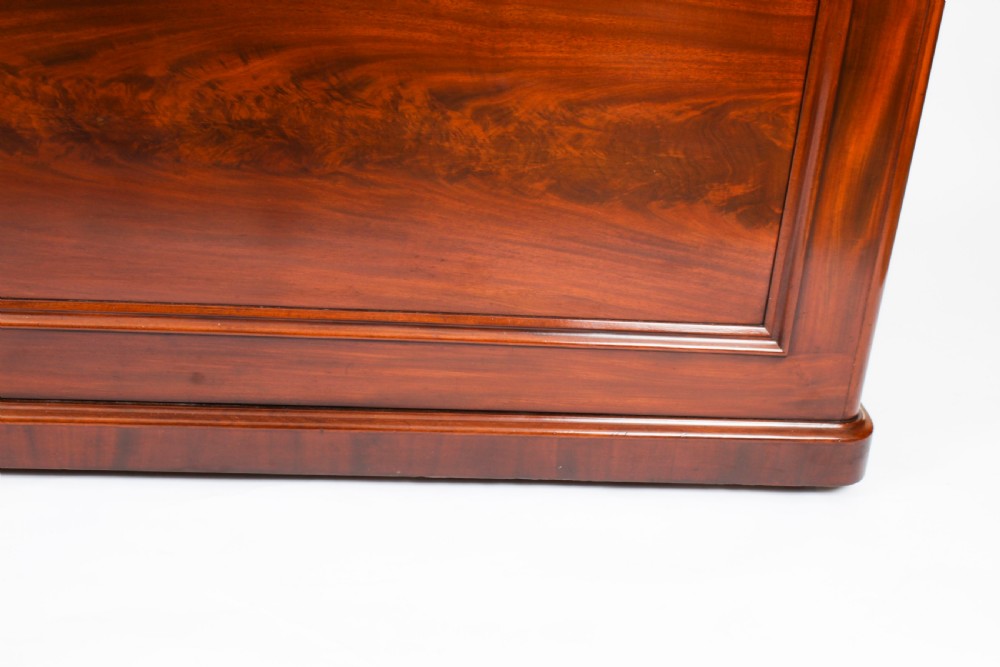A Victorian flame mahogany dry bar featuring an elevated upper shelf supported by four turned balusters over a panelled lower counter. View XI