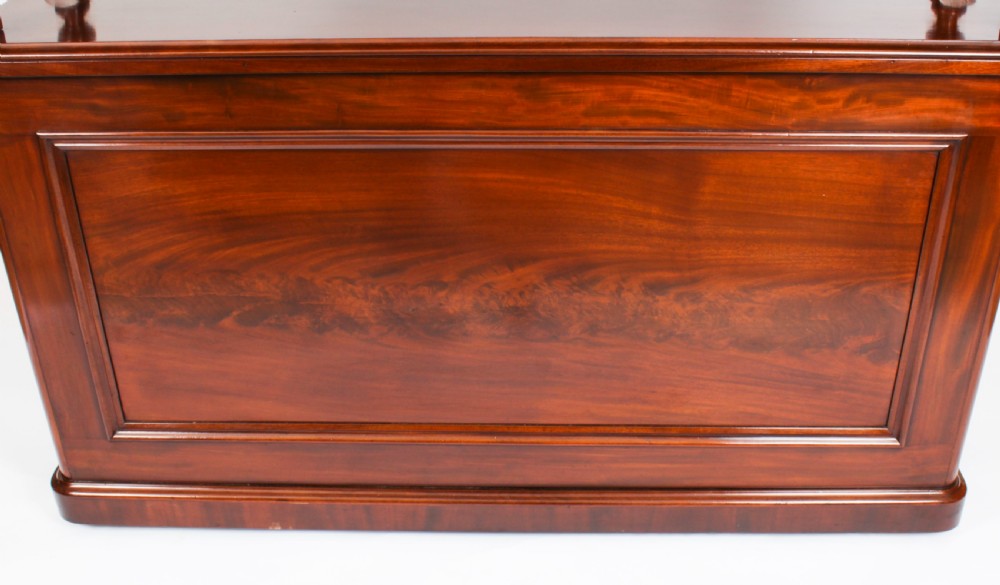 A Victorian flame mahogany dry bar featuring an elevated upper shelf supported by four turned balusters over a panelled lower counter. View XXIII