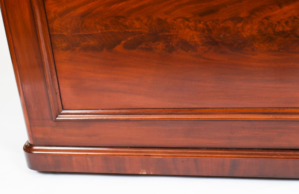 A Victorian flame mahogany dry bar featuring an elevated upper shelf supported by four turned balusters over a panelled lower counter. View XXIV