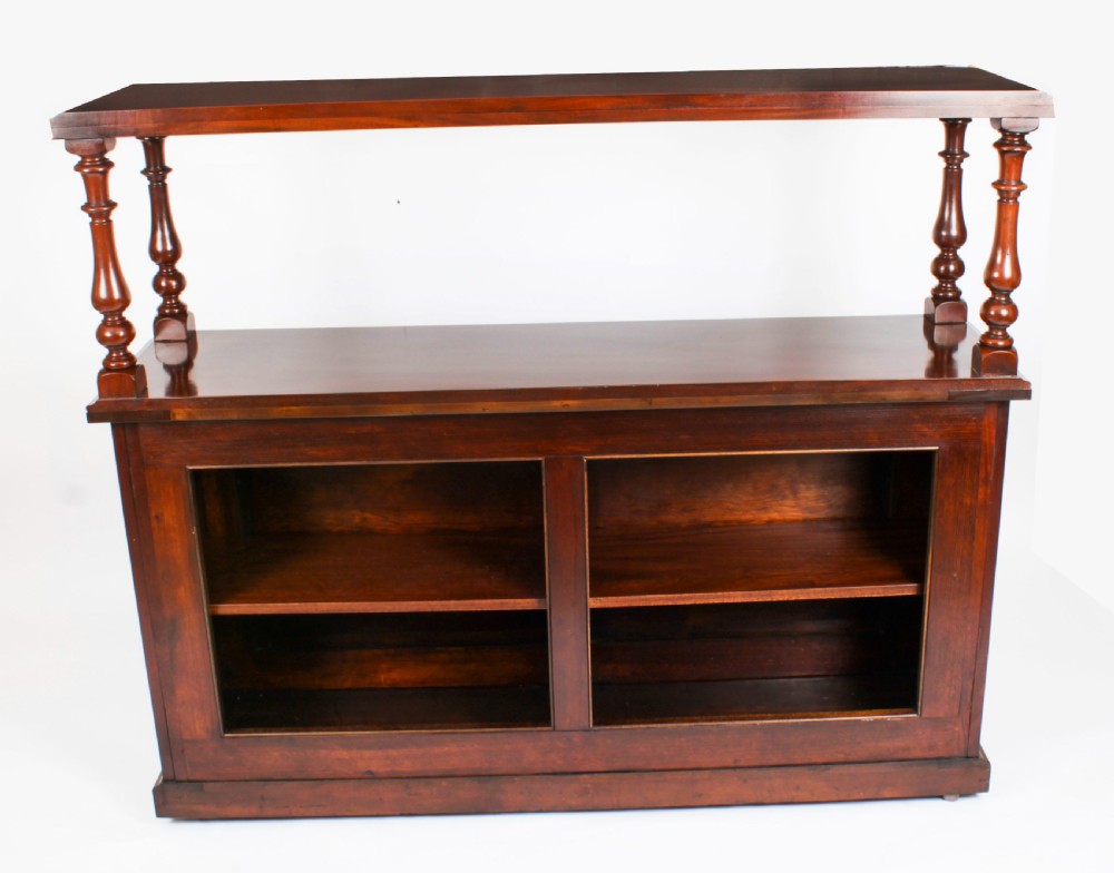 A Victorian flame mahogany dry bar featuring an elevated upper shelf supported by four turned balusters over a panelled lower counter. View XXVI
