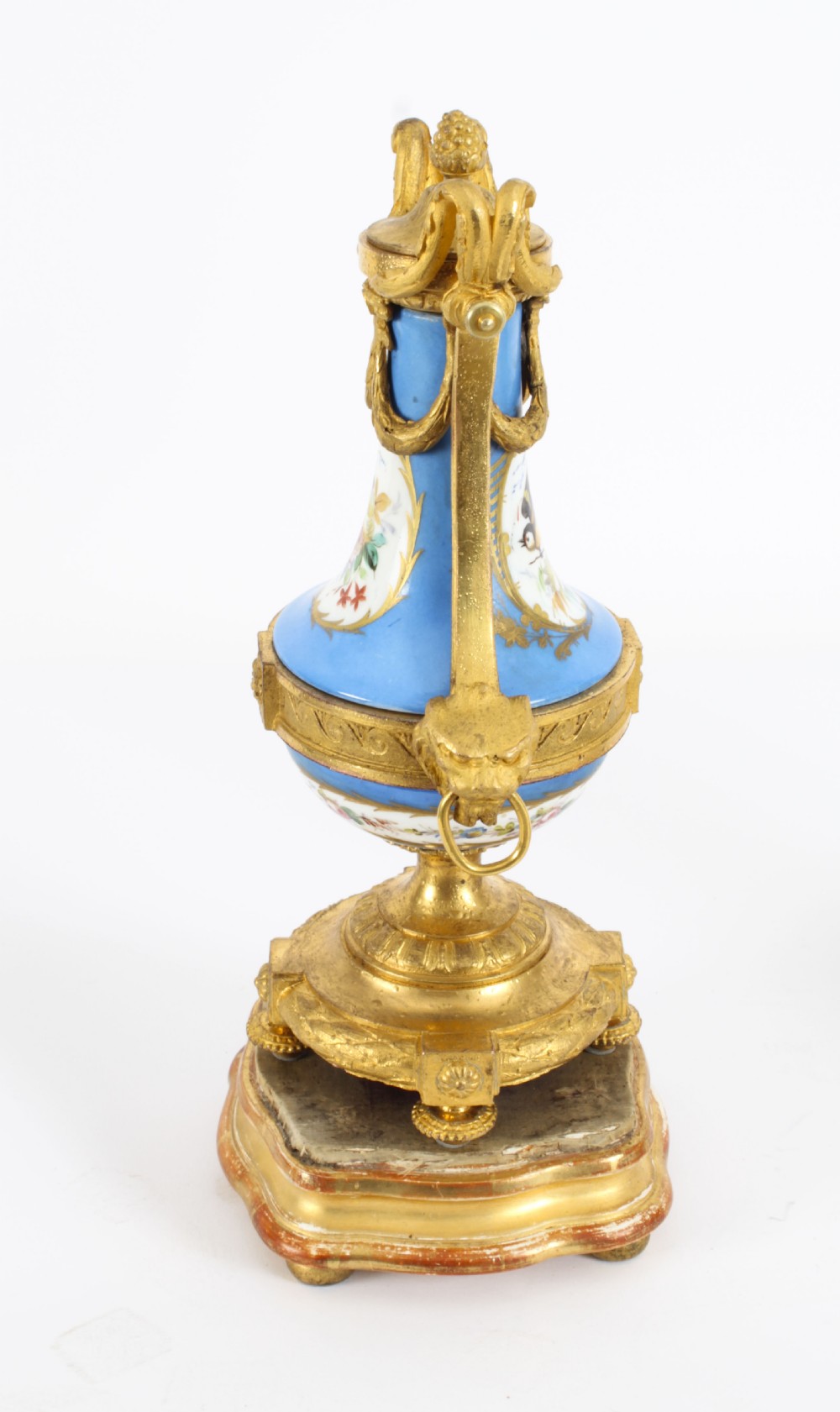 A pair of 19th-century French Sevres-style bleu celeste porcelain urns featuring hand-painted floral and bird reserves, supported by gilt metal mounts and pedestals. View VIII