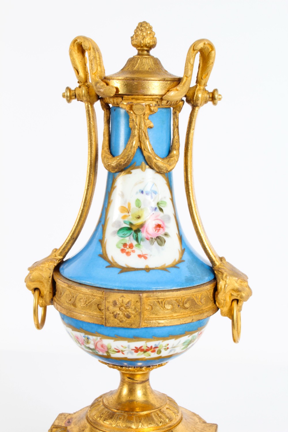 A pair of 19th-century French Sevres-style bleu celeste porcelain urns featuring hand-painted floral and bird reserves, supported by gilt metal mounts and pedestals. View XIII
