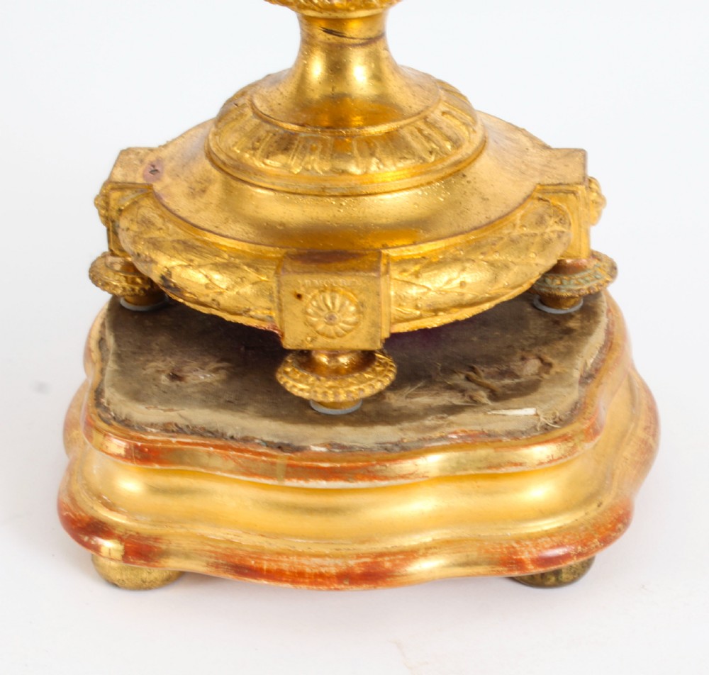 A pair of 19th-century French Sevres-style bleu celeste porcelain urns featuring hand-painted floral and bird reserves, supported by gilt metal mounts and pedestals. View XVIII