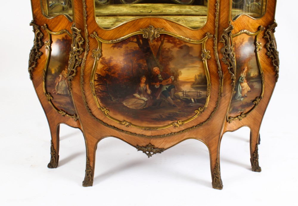 A nineteenth-century French Louis XV style bombee vitrine cabinet featuring curved glass panels, hand-painted Vernis Martin lower sections, and ornate gilt bronze mounts. View VIII