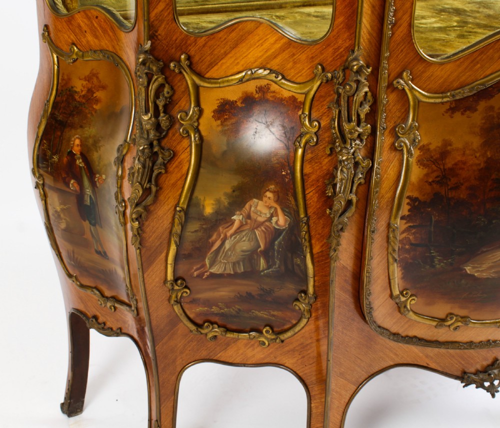 A nineteenth-century French Louis XV style bombee vitrine cabinet featuring curved glass panels, hand-painted Vernis Martin lower sections, and ornate gilt bronze mounts. View XII