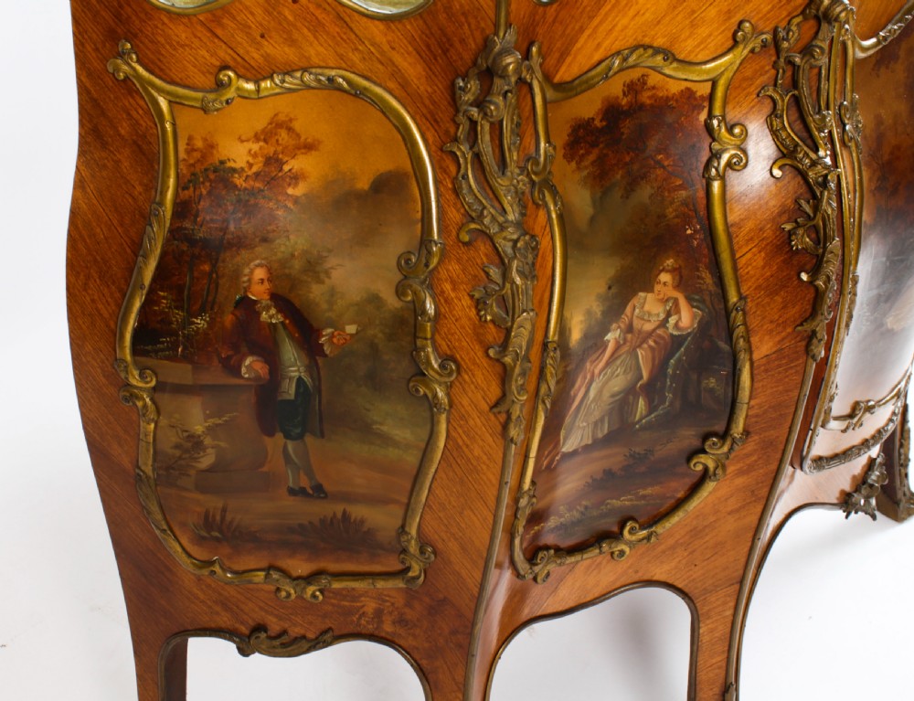 A nineteenth-century French Louis XV style bombee vitrine cabinet featuring curved glass panels, hand-painted Vernis Martin lower sections, and ornate gilt bronze mounts. View XV