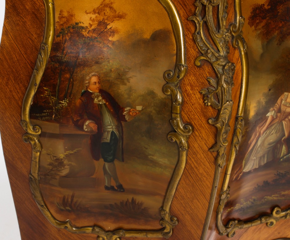 A nineteenth-century French Louis XV style bombee vitrine cabinet featuring curved glass panels, hand-painted Vernis Martin lower sections, and ornate gilt bronze mounts. View XVI