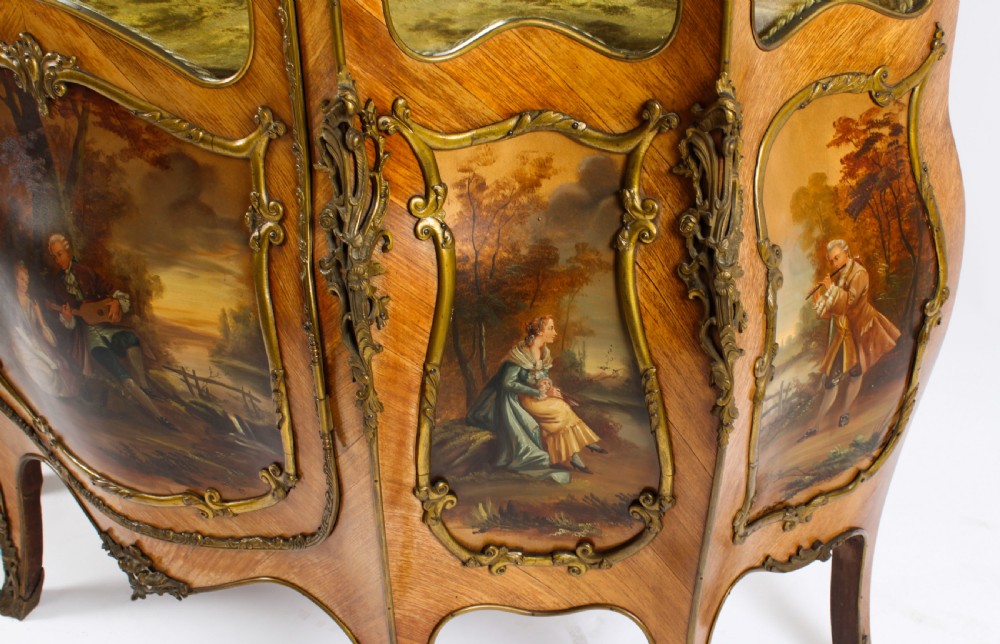 A nineteenth-century French Louis XV style bombee vitrine cabinet featuring curved glass panels, hand-painted Vernis Martin lower sections, and ornate gilt bronze mounts. View XXI