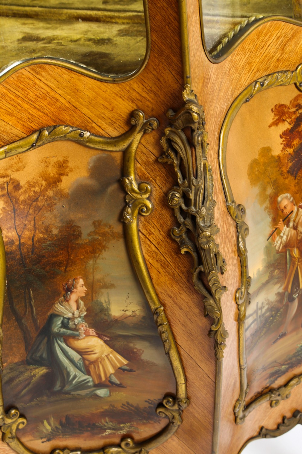 A nineteenth-century French Louis XV style bombee vitrine cabinet featuring curved glass panels, hand-painted Vernis Martin lower sections, and ornate gilt bronze mounts. View XXIII