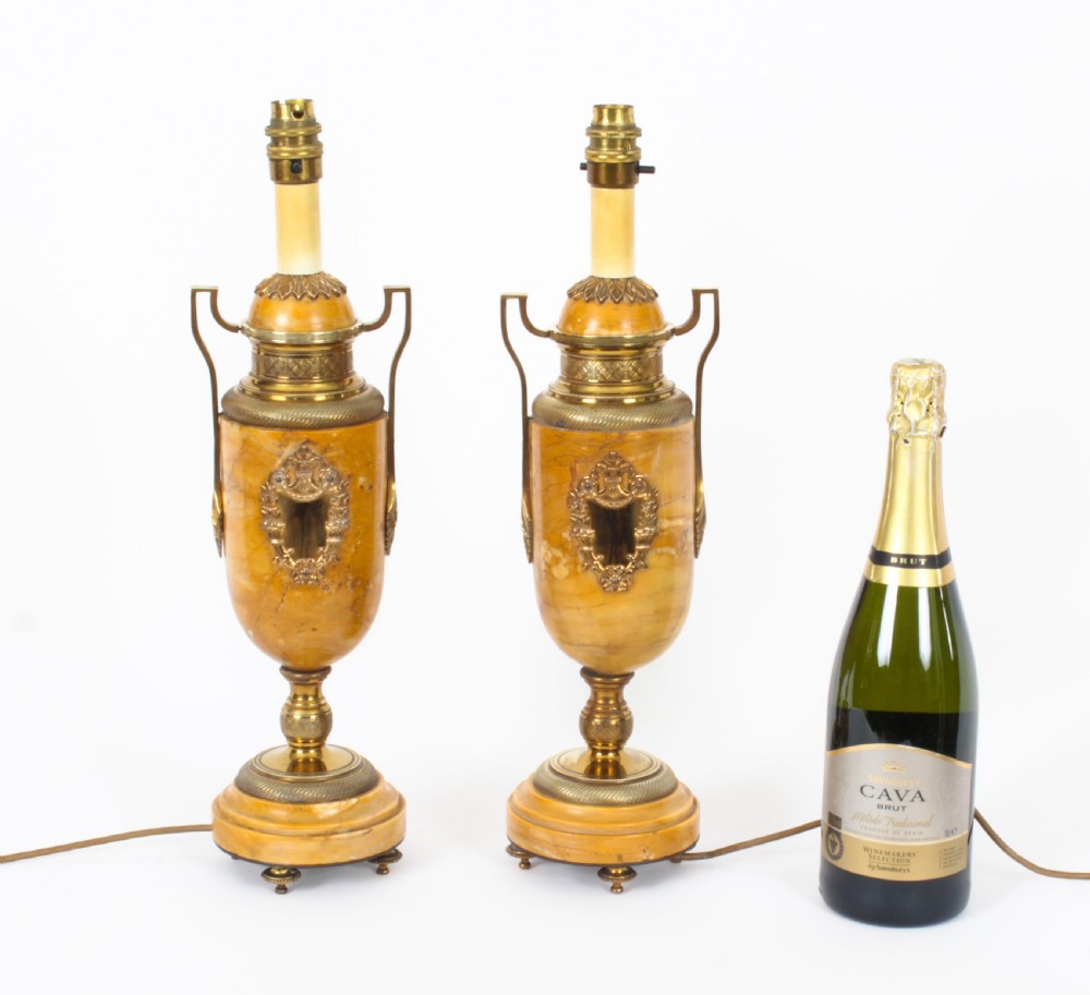 A pair of 19th-century French urn-form Siena marble table lamps featuring detailed gilt bronze mounts and handles. View XX