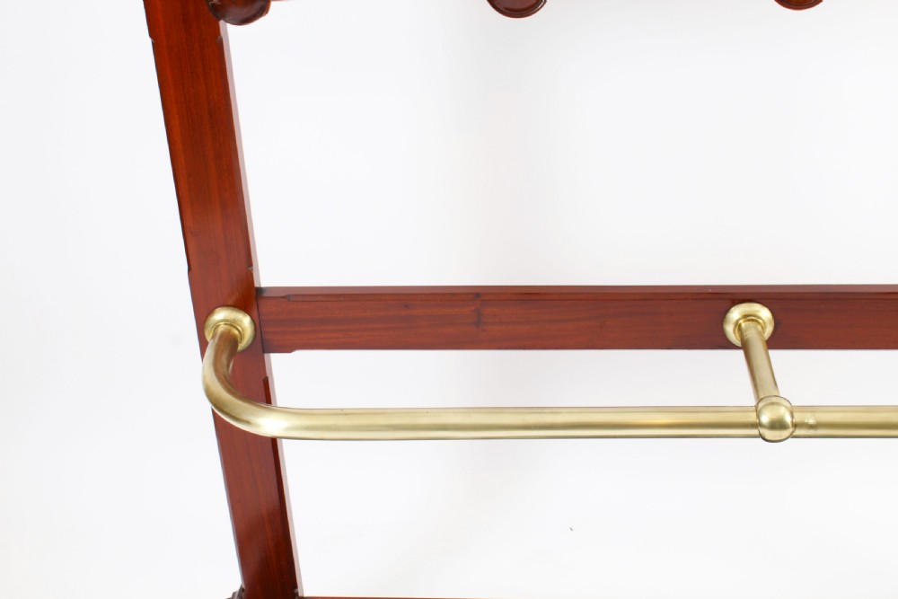 A Victorian mahogany hall stand featuring an arched fretwork top with wooden peg hooks, a brass umbrella bar, and a fitted drip pan base. View XI
