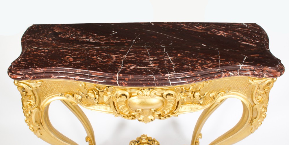 A 19th-century Louis Revival carved giltwood console table with cabriole legs and a dark red marble top. View III