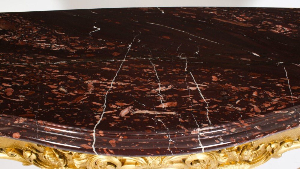 A 19th-century Louis Revival carved giltwood console table with cabriole legs and a dark red marble top. View IV