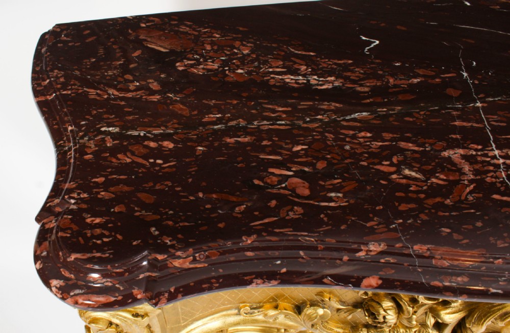 A 19th-century Louis Revival carved giltwood console table with cabriole legs and a dark red marble top. View V