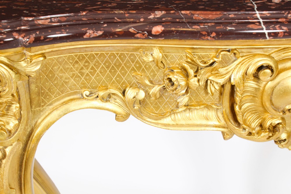 A 19th-century Louis Revival carved giltwood console table with cabriole legs and a dark red marble top. View X