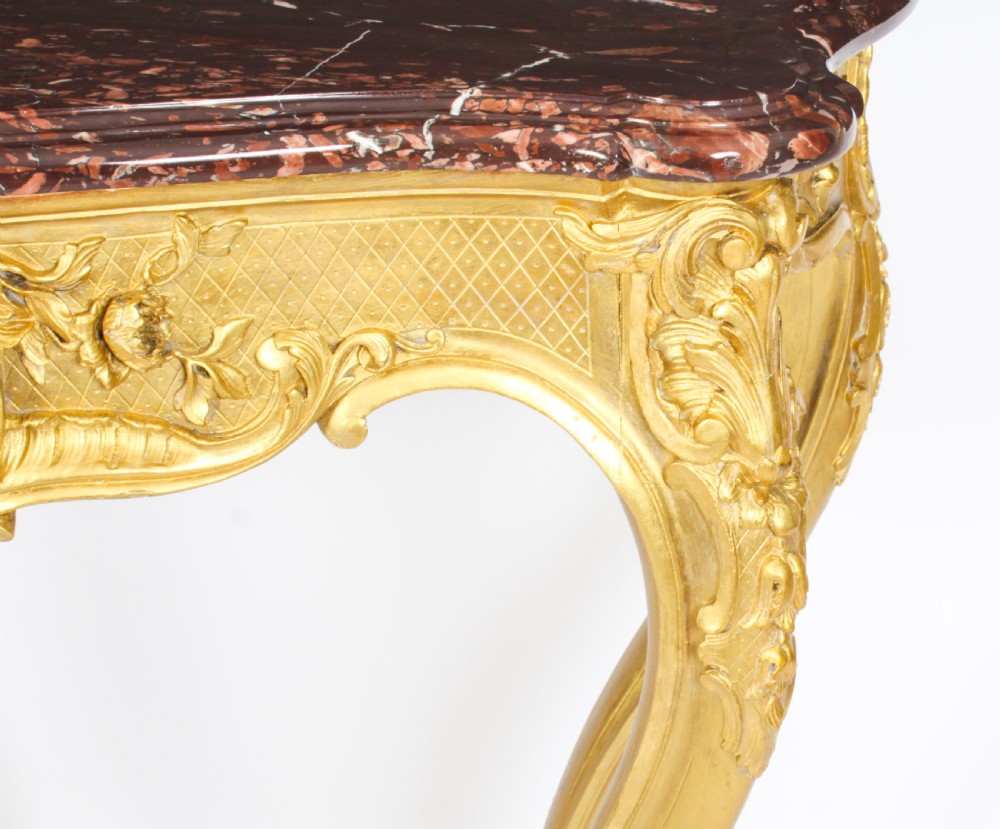 A 19th-century Louis Revival carved giltwood console table with cabriole legs and a dark red marble top. View XI