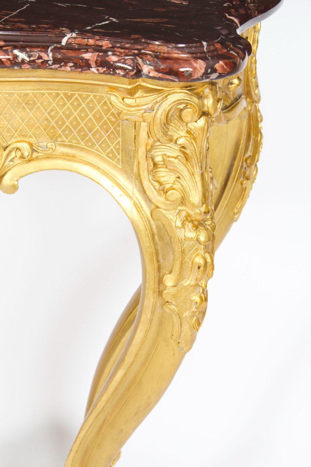 A 19th-century Louis Revival carved giltwood console table with cabriole legs and a dark red marble top. View XII