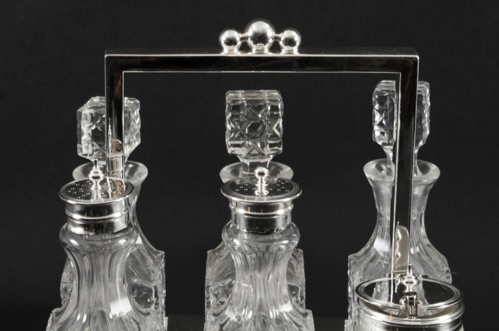 A Victorian silver-plated rectangular cruet stand holding six faceted cut-glass condiment bottles with metal tops and glass stoppers. View III