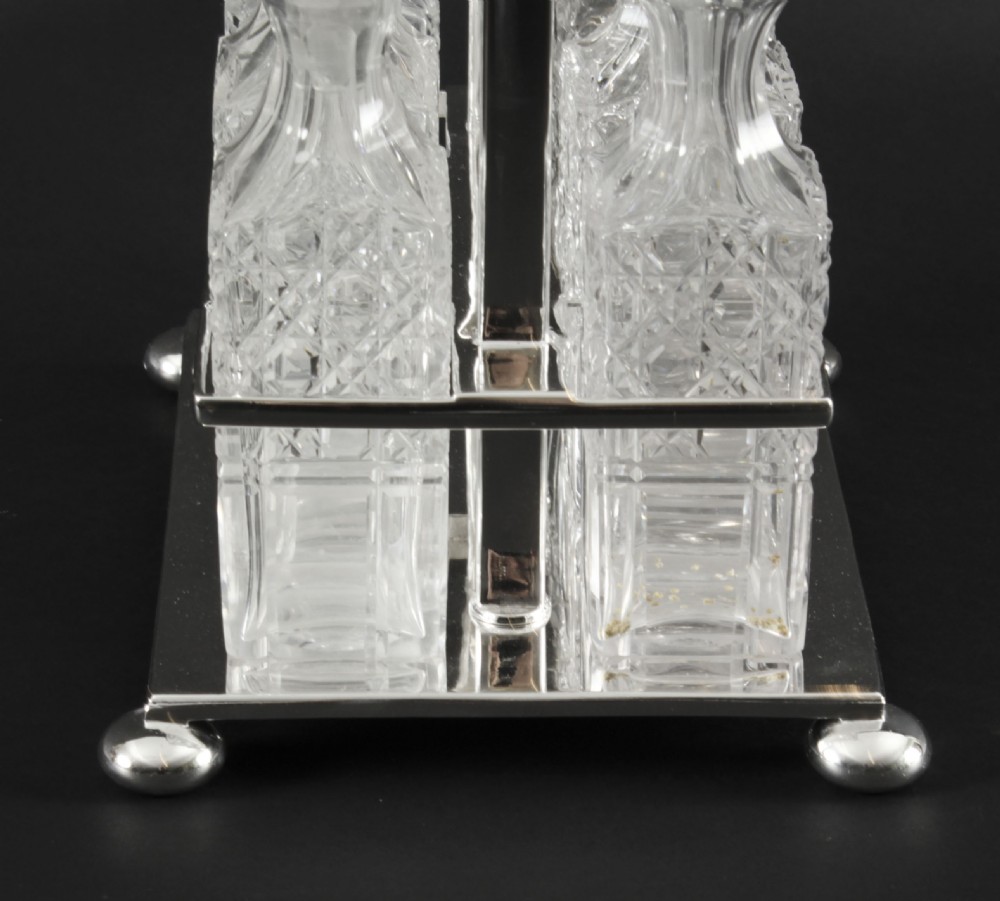 A Victorian silver-plated rectangular cruet stand holding six faceted cut-glass condiment bottles with metal tops and glass stoppers. View VIII