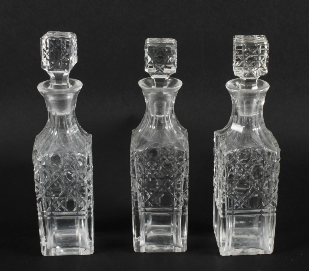 A Victorian silver-plated rectangular cruet stand holding six faceted cut-glass condiment bottles with metal tops and glass stoppers. View XIII