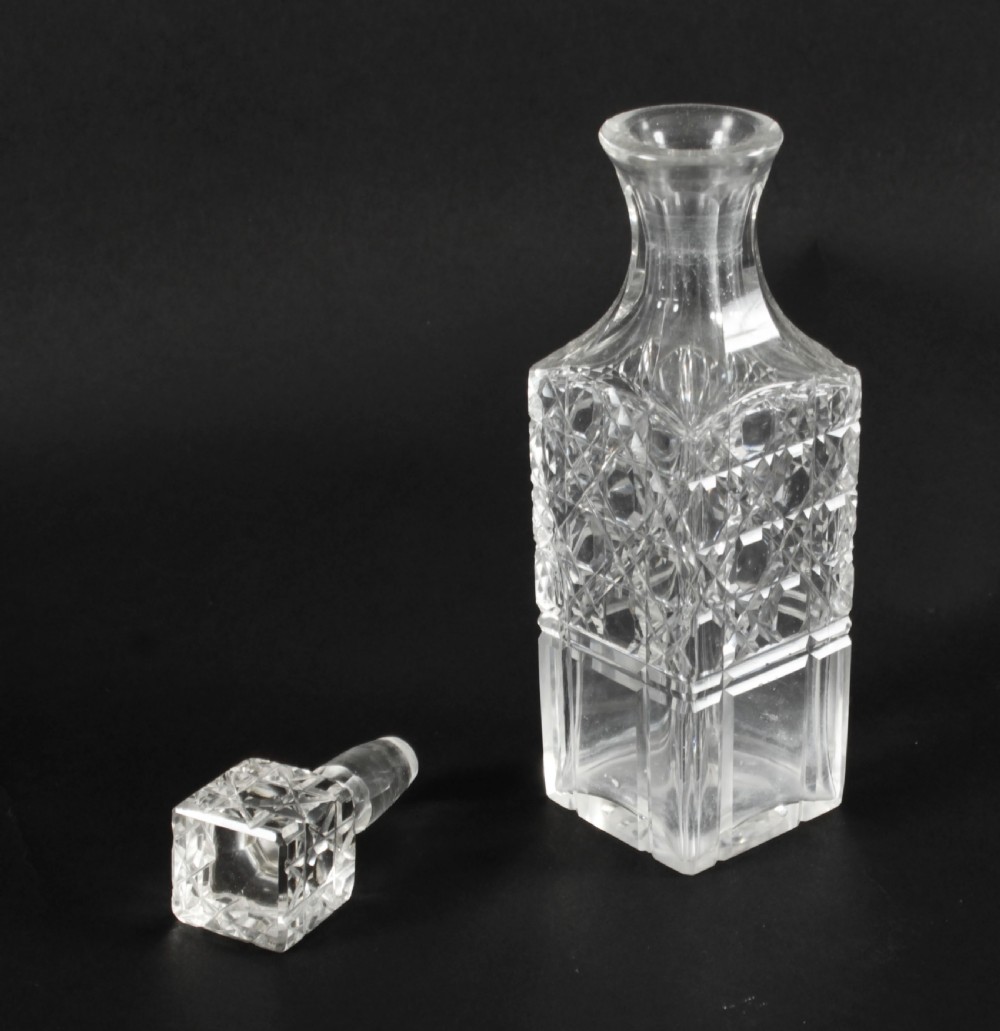 A Victorian silver-plated rectangular cruet stand holding six faceted cut-glass condiment bottles with metal tops and glass stoppers. View XVI