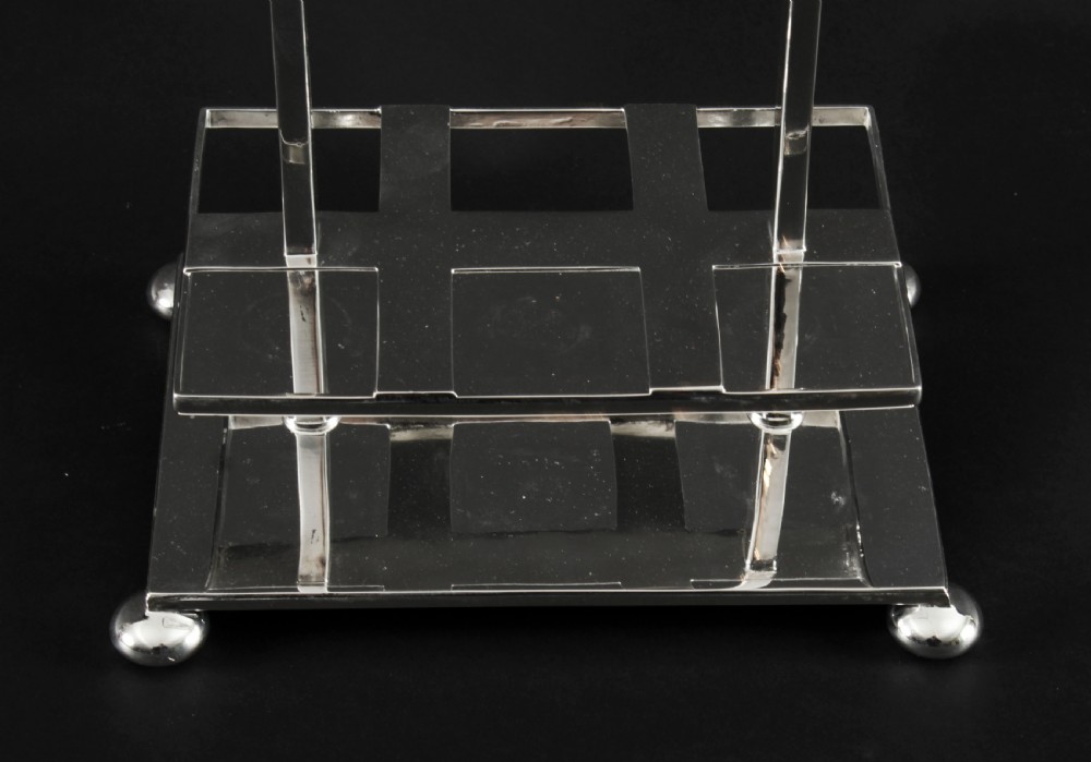 A Victorian silver-plated rectangular cruet stand holding six faceted cut-glass condiment bottles with metal tops and glass stoppers. View XXV