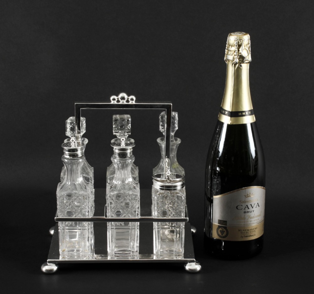 A Victorian silver-plated rectangular cruet stand holding six faceted cut-glass condiment bottles with metal tops and glass stoppers. View XXVI