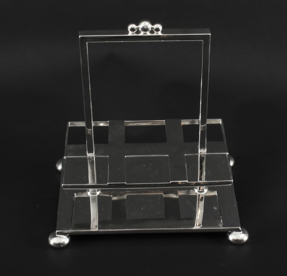 A Victorian silver-plated rectangular cruet stand holding six faceted cut-glass condiment bottles with metal tops and glass stoppers. View XXVIII