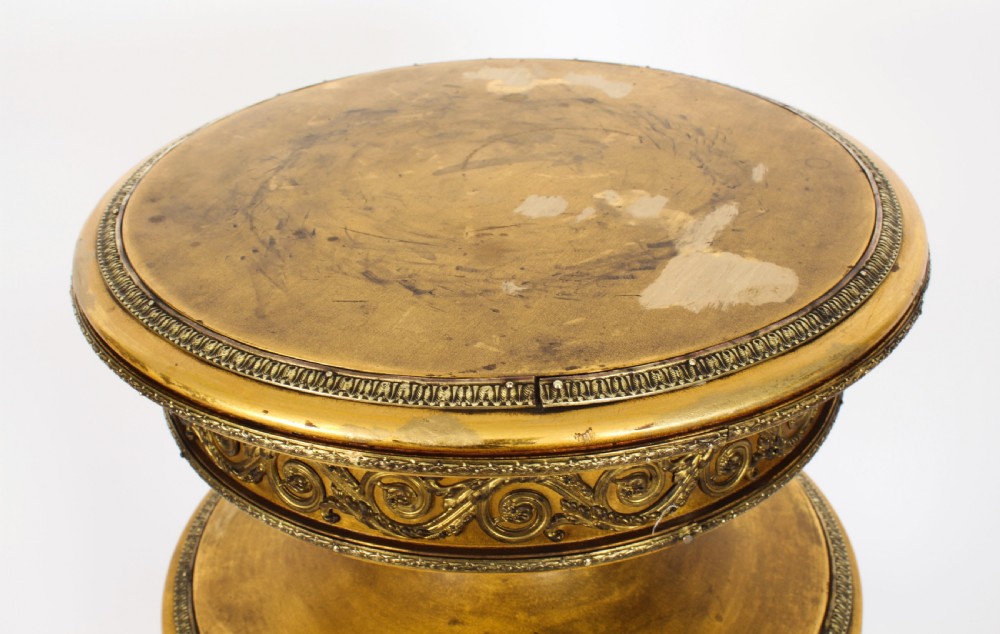 A 19th-century French giltwood cylindrical pedestal display cabinet featuring curved glass panels, an interior shelf, and carved guilloche mouldings. View VIII