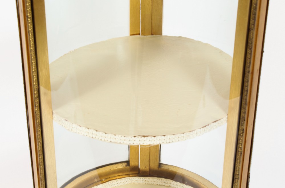 A 19th-century French giltwood cylindrical pedestal display cabinet featuring curved glass panels, an interior shelf, and carved guilloche mouldings. View XIV