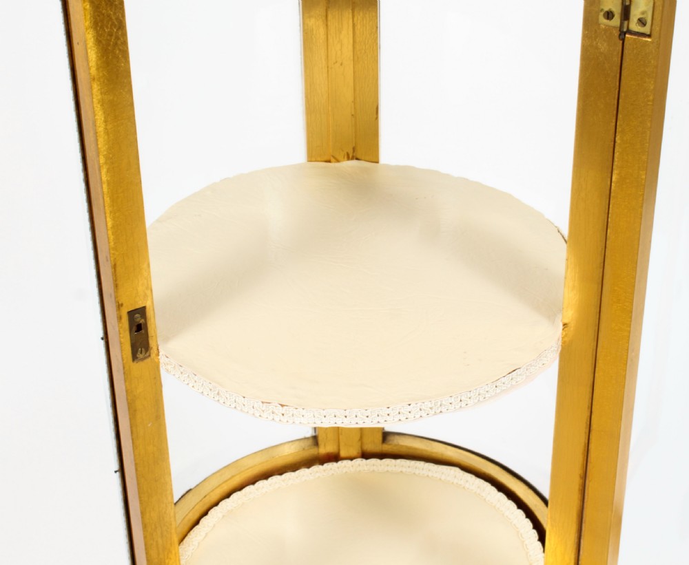 A 19th-century French giltwood cylindrical pedestal display cabinet featuring curved glass panels, an interior shelf, and carved guilloche mouldings. View XVI