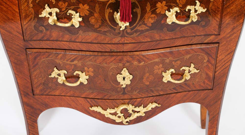 A 19th-century French Louis XV Revival commode with floral marquetry inlay, a variegated marble top, three drawers, and gilt-bronze mounts. View XII