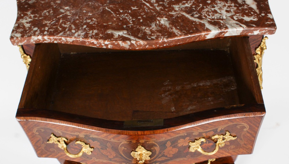 A 19th-century French Louis XV Revival commode with floral marquetry inlay, a variegated marble top, three drawers, and gilt-bronze mounts. View XIV