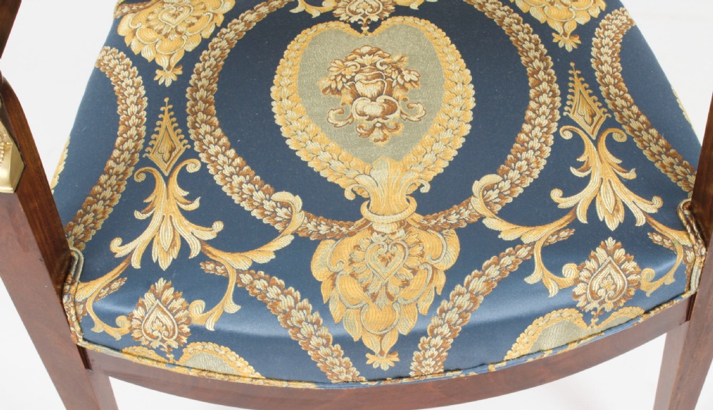 A pair of 19th-century French Empire Revival mahogany armchairs upholstered in blue and gold patterned silk damask featuring gilt ormolu mounts. View VI