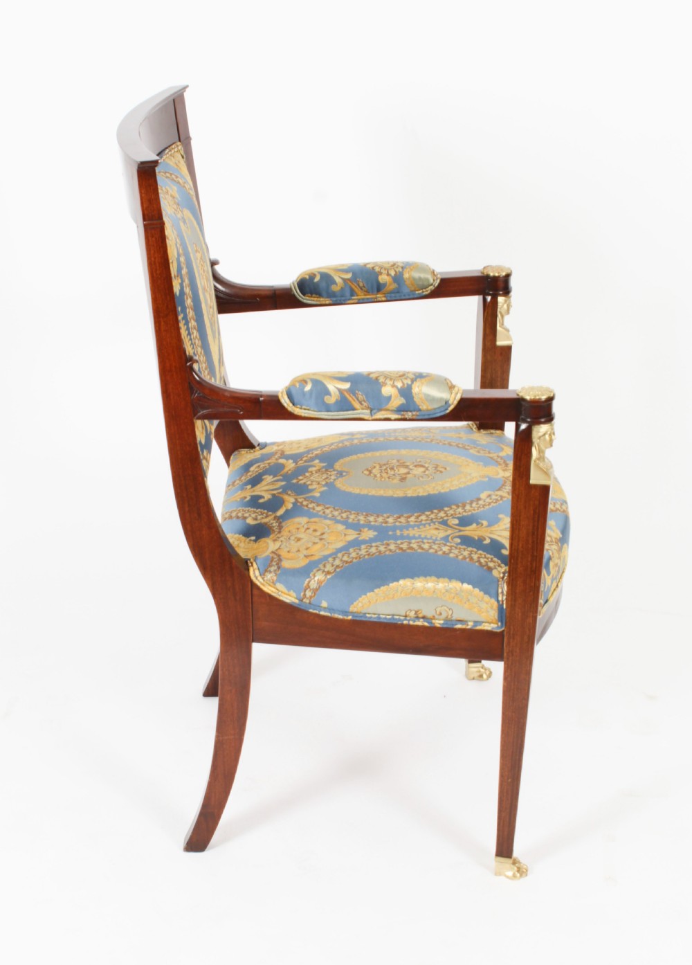 A pair of 19th-century French Empire Revival mahogany armchairs upholstered in blue and gold patterned silk damask featuring gilt ormolu mounts. View IX