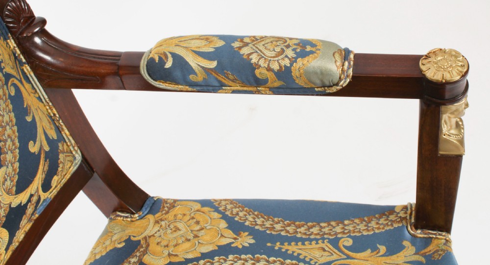 A pair of 19th-century French Empire Revival mahogany armchairs upholstered in blue and gold patterned silk damask featuring gilt ormolu mounts. View XIV