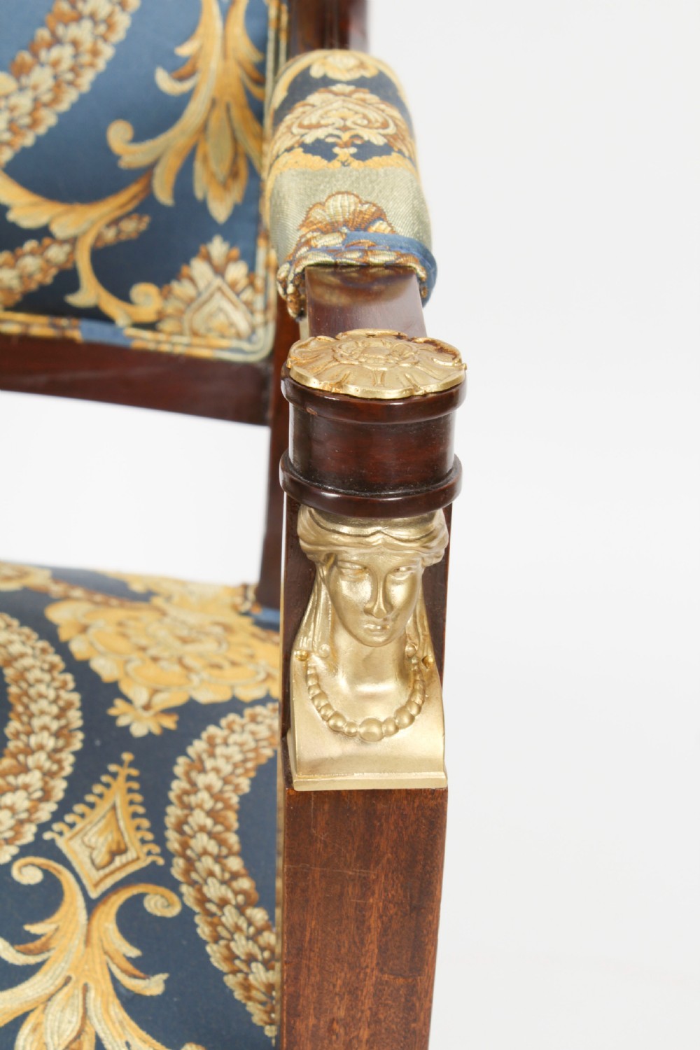 A pair of 19th-century French Empire Revival mahogany armchairs upholstered in blue and gold patterned silk damask featuring gilt ormolu mounts. View XVII