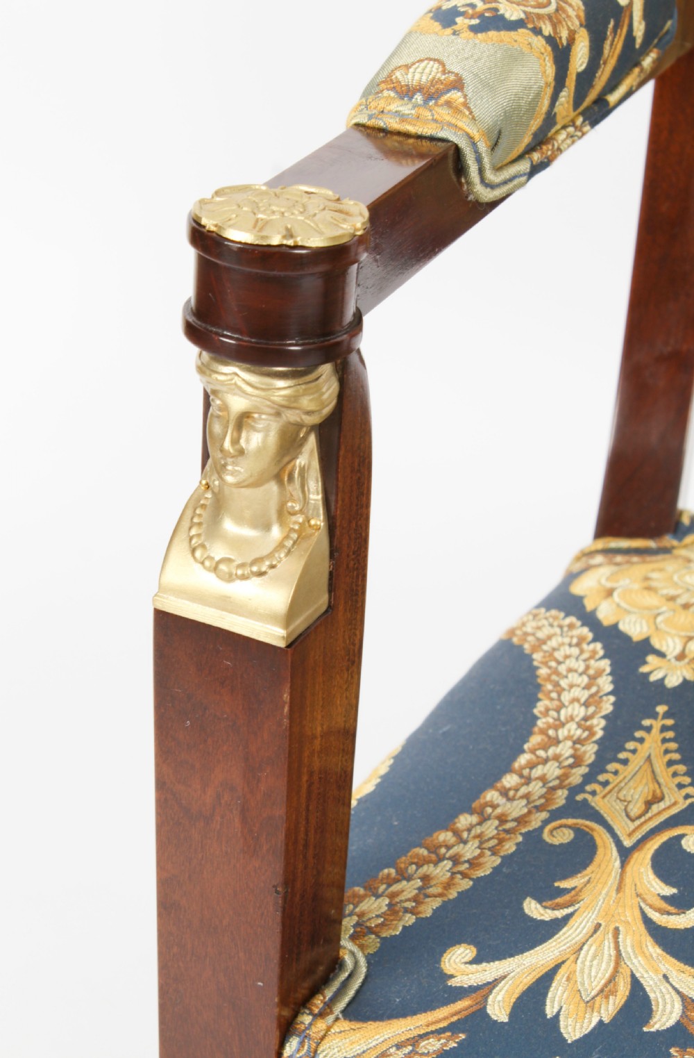 A pair of 19th-century French Empire Revival mahogany armchairs upholstered in blue and gold patterned silk damask featuring gilt ormolu mounts. View XVIII