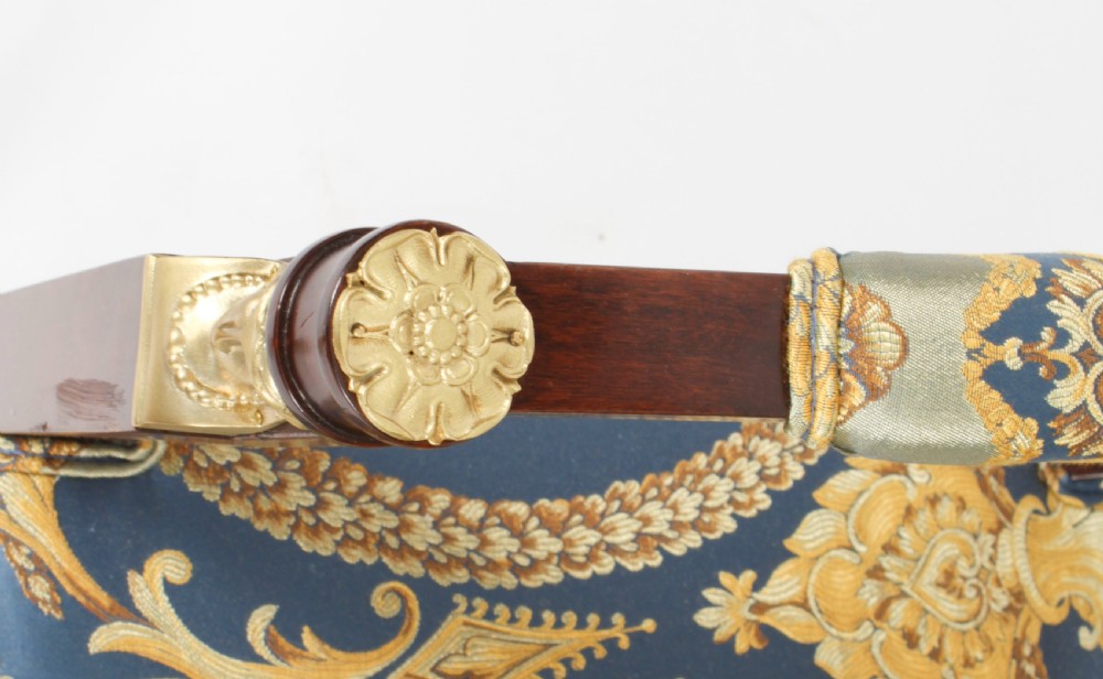 A pair of 19th-century French Empire Revival mahogany armchairs upholstered in blue and gold patterned silk damask featuring gilt ormolu mounts. View XX