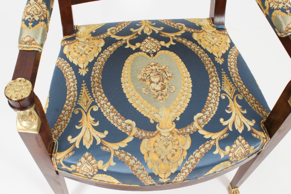 A pair of 19th-century French Empire Revival mahogany armchairs upholstered in blue and gold patterned silk damask featuring gilt ormolu mounts. View XXI